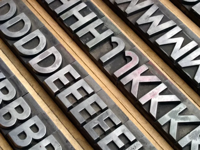Lead typeface blocks organized in storage holders.